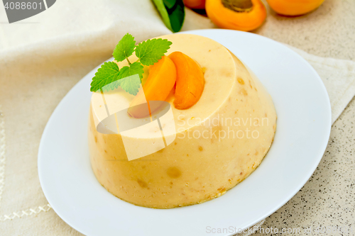 Image of Panna cotta apricot with mint on napkin