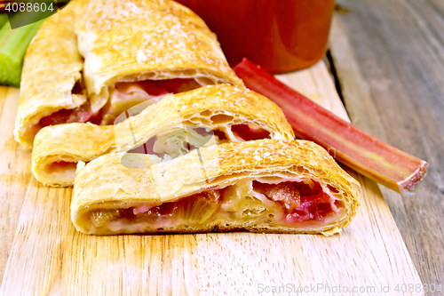 Image of Strudel with rhubarb and mug on wooden board