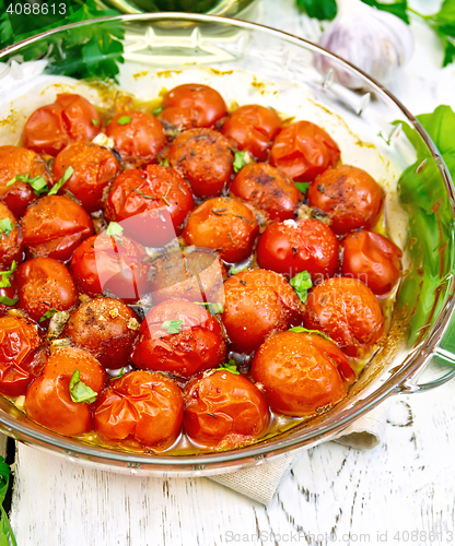 Image of Tomatoes baked in glass pan on board