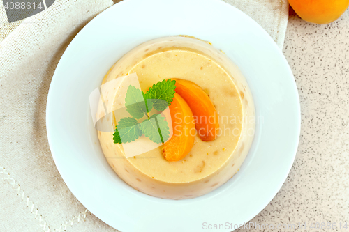 Image of Panna cotta apricot with mint on napkin top