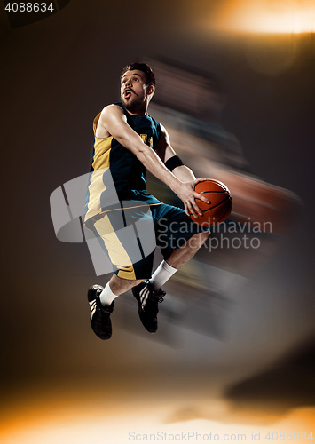 Image of Full length portrait of a basketball player with ball