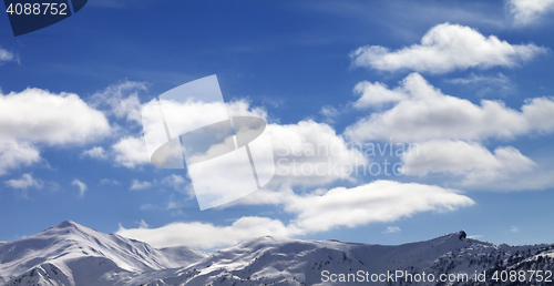 Image of Panoramic view on sunlight snow mountains and blue sky with clou