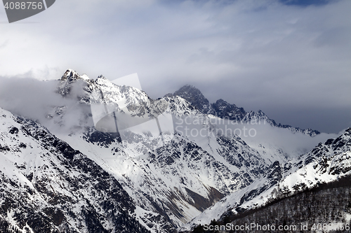Image of Sunlight mountains and gray cloudy sky