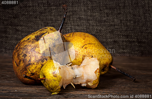 Image of Two pears and stub on wooden table