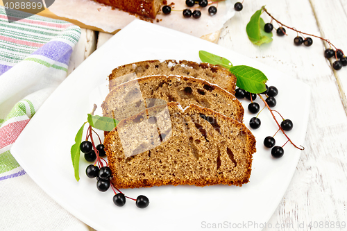 Image of Fruitcake bird cherry in plate on light board