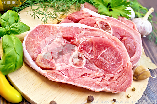 Image of Turkey steak raw with garlic on board