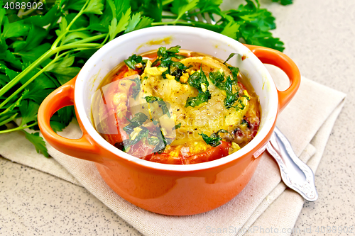 Image of Fish baked with tomato in red pot on granite table