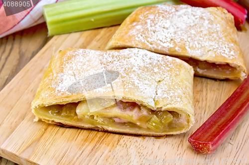 Image of Strudel with rhubarb and napkin on wooden board