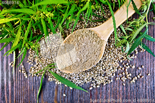 Image of Flour hemp in spoon with leaf and grain on board top