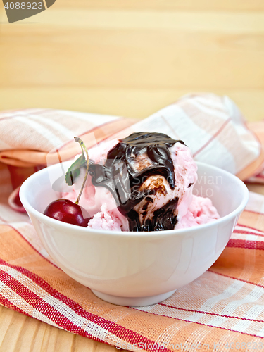 Image of Ice cream cherry with chocolate syrup on board