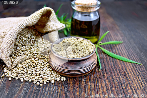 Image of Flour hemp in bowl with leaf and oil on board