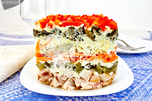 Image of Salad with chicken and peppers on blue tablecloth