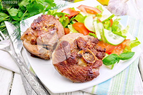 Image of Turkey steak roasted with vegetables on table