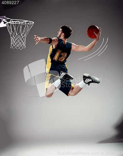 Image of Full length portrait of a basketball player with ball