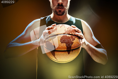 Image of Silhouette view of a basketball player holding basket ball on black background
