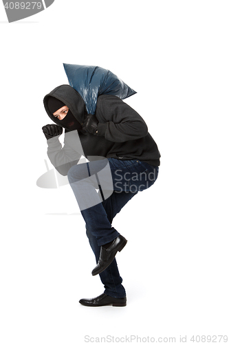 Image of Burglar with bag on shoulder