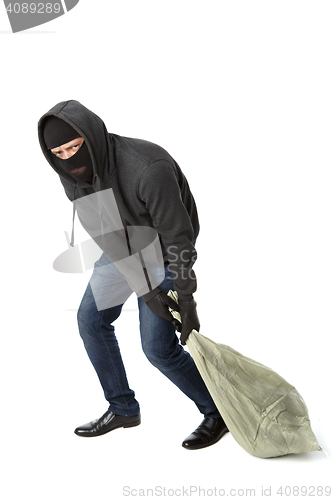 Image of Thief in gloves drags bag