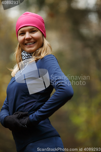 Image of Sporty girl on autumn landscape