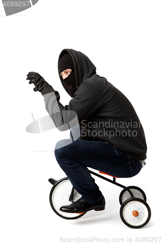 Image of Robber on small children\'s bicycle