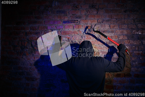 Image of Gunman surrenders standing against wall