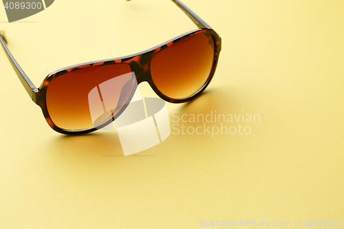 Image of Sunglasses in empty yellow background