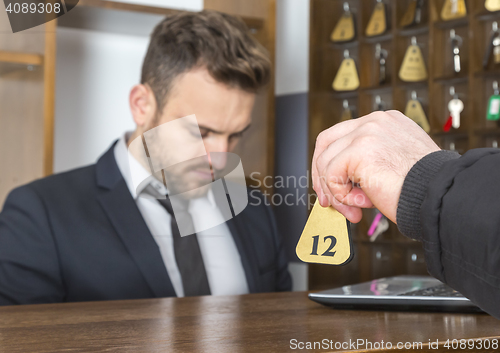 Image of Guest Giving the Key at the Reception