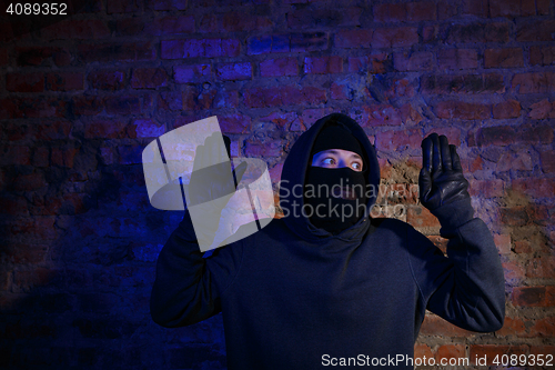 Image of Surprised burglar with hands up