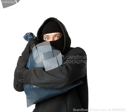 Image of Terrible mugger holding large bag