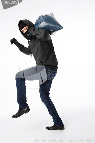 Image of Thief in gloves with bag