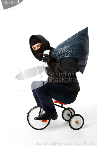 Image of Burglar coming on children\'s bike