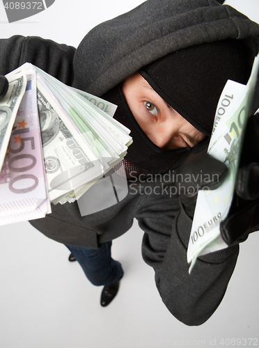 Image of Burglar in mask with money