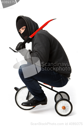 Image of Robber going on children\'s bicycle