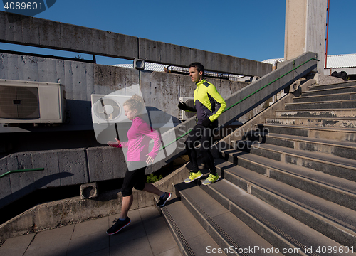 Image of young  couple jogging on steps
