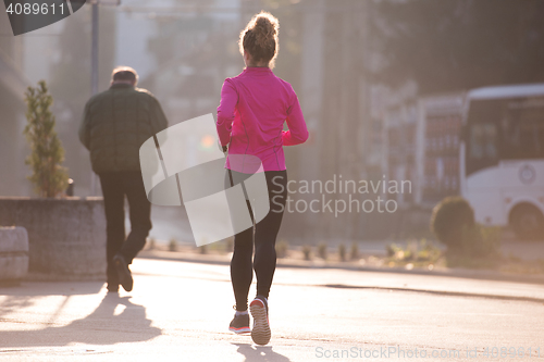 Image of sporty woman jogging on morning