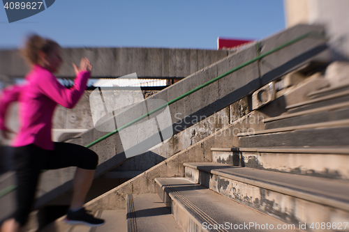 Image of woman jogging on  steps