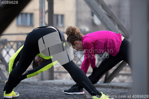 Image of couple warming up before jogging