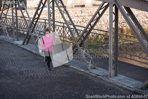 Image of sporty woman jogging on morning