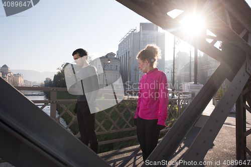 Image of couple warming up before jogging