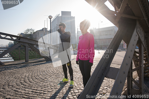 Image of couple warming up before jogging