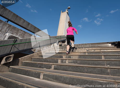 Image of woman jogging on  steps