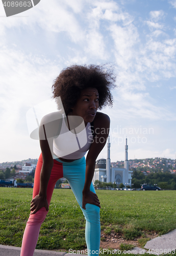 Image of Portrait of sporty young african american woman running outdoors