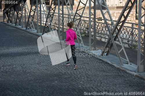Image of sporty woman jogging on morning