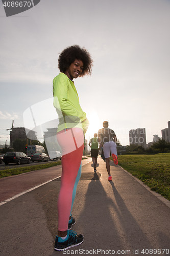 Image of Portrait of sporty young african american woman running outdoors