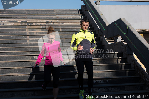 Image of young  couple jogging on steps