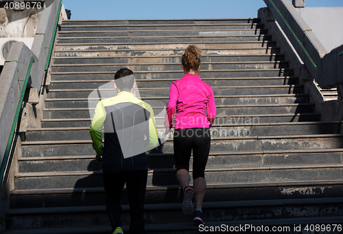 Image of young  couple jogging on steps