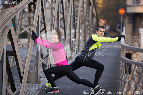 Image of couple warming up before jogging