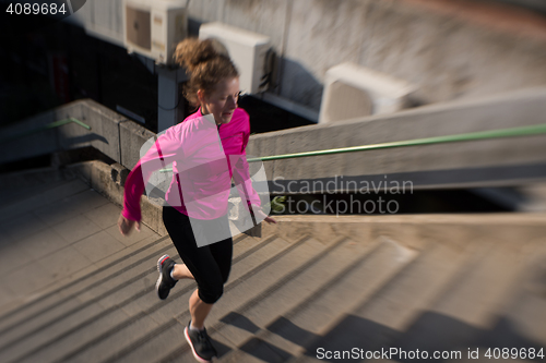 Image of woman jogging on  steps