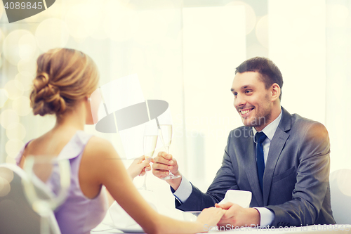 Image of couple with glasses of champagne at restaurant