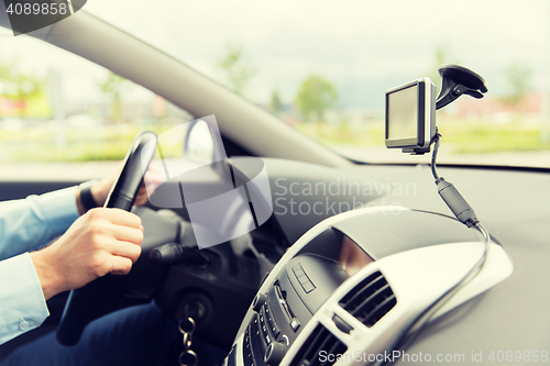 Image of close up of man with gps navigator driving car