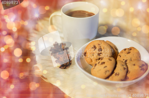 Image of cups of hot chocolate with cookies on fur rug